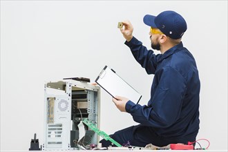 Sideways man repairing computer