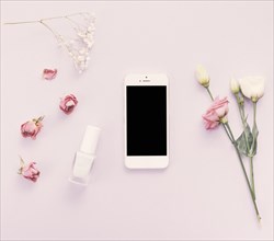 Smartphone with roses nail polish table