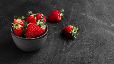 Strawberries bowl black table