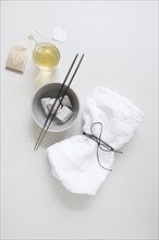 Teabag oil pumice stone incense stick tied napkin white surface