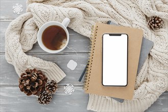 Top view blank phone agendas with tea mug