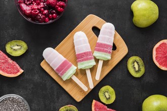 Top view delicious popsicles with fruit