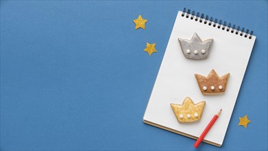 Top view notebook with three crowns stars epiphany day