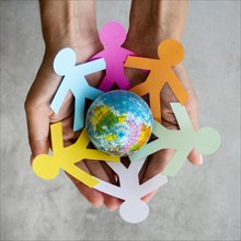 Top view origami chain people with globe