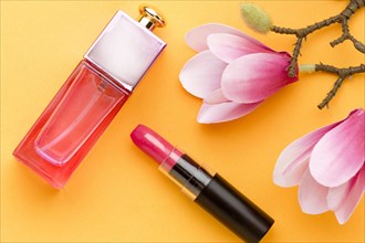 Top view perfume with lipstick flowers