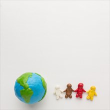 Top view plasticine globe people with copy space