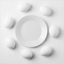 Top view white chicken eggs table with plate