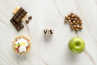 Unhealthy creamy tart chocolate vs healthy hazelnut apple texture background