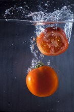 Water background with tomato slice tomato
