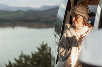 Woman enjoying nature view from car while road trip