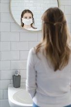 Woman quarantine looking mirror