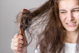 Woman struggling brush hair