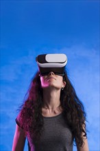 Woman using virtual reality headset outdoors