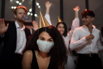 Woman wearing medical mask her friends new year s eve party