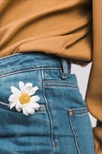 Woman with daisy flower jeans pocket