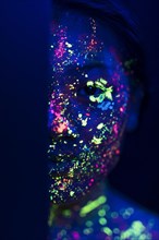 Woman with fluorescent make up half face