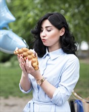 Young woman eating bubble waffle