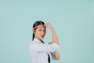 Asian woman showing biceps