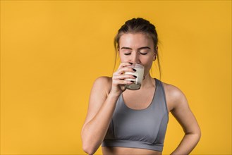 Attractive young woman sportswear drinking milk