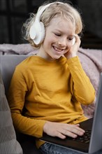 Boy couch with laptop headphones