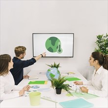 Businessman showing global warming icon his colleagues screen
