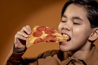 Close up kid eating pizza