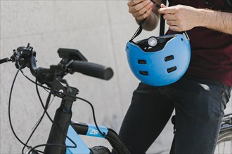 Close up man holding helmet bicycle