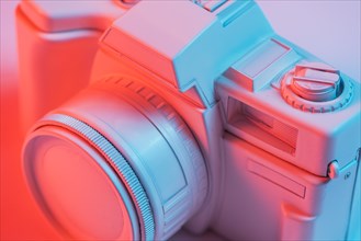 Close up retro pink camera with blue light