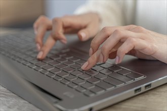 Close up woman typing laptop