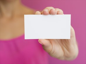 Close up woman with pink shirt white card
