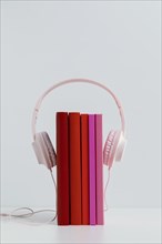 Colorful books with pink headphones