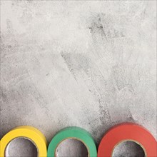 Colorful insulating tape row concrete backdrop
