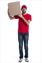 Courier man holding his shoulder big delivery box long view