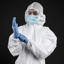 Doctor with putting surgical gloves