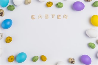 Easter inscription with colorful eggs table