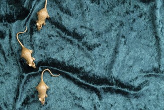 Flat lay rat figurines turquoise velvet