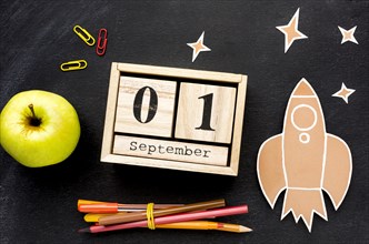Flat lay school essentials with calendar apple