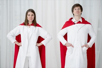Front view doctors posing with capes