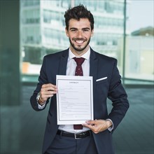 Front view happy man holding contract