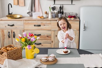 Happy little girl making cupcake