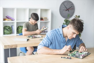 Hardware technician students practicing with computer components