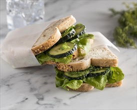 High angle sandwiches with greens cucumber