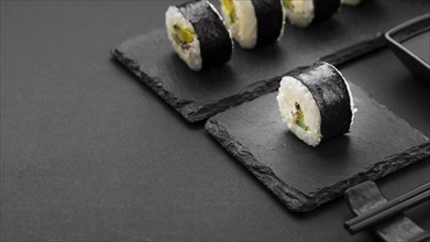High angle sushi rolls slate with copy space