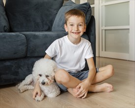 Little kid posing with his dog