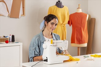 Medium shot smiley woman sewing with machine