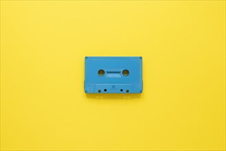 Radio concept with cassette yellow background
