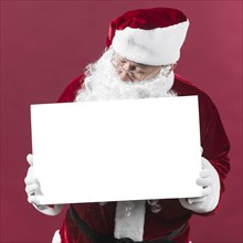 Santa claus holding blank white paper hands