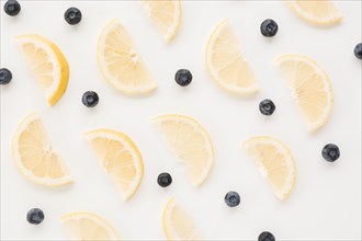 Seamless pattern blueberries lemon slices white backdrop