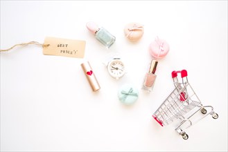 Shopping trolley with little alarm clock macaroons sale tag lipstick nail polish