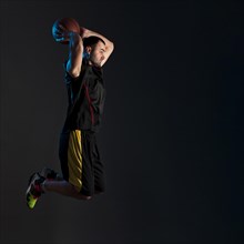Side view basketball player dunking with copy space